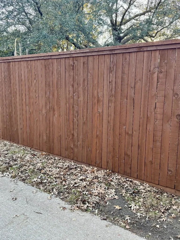 Freshly stained Sable Brown privacy fence